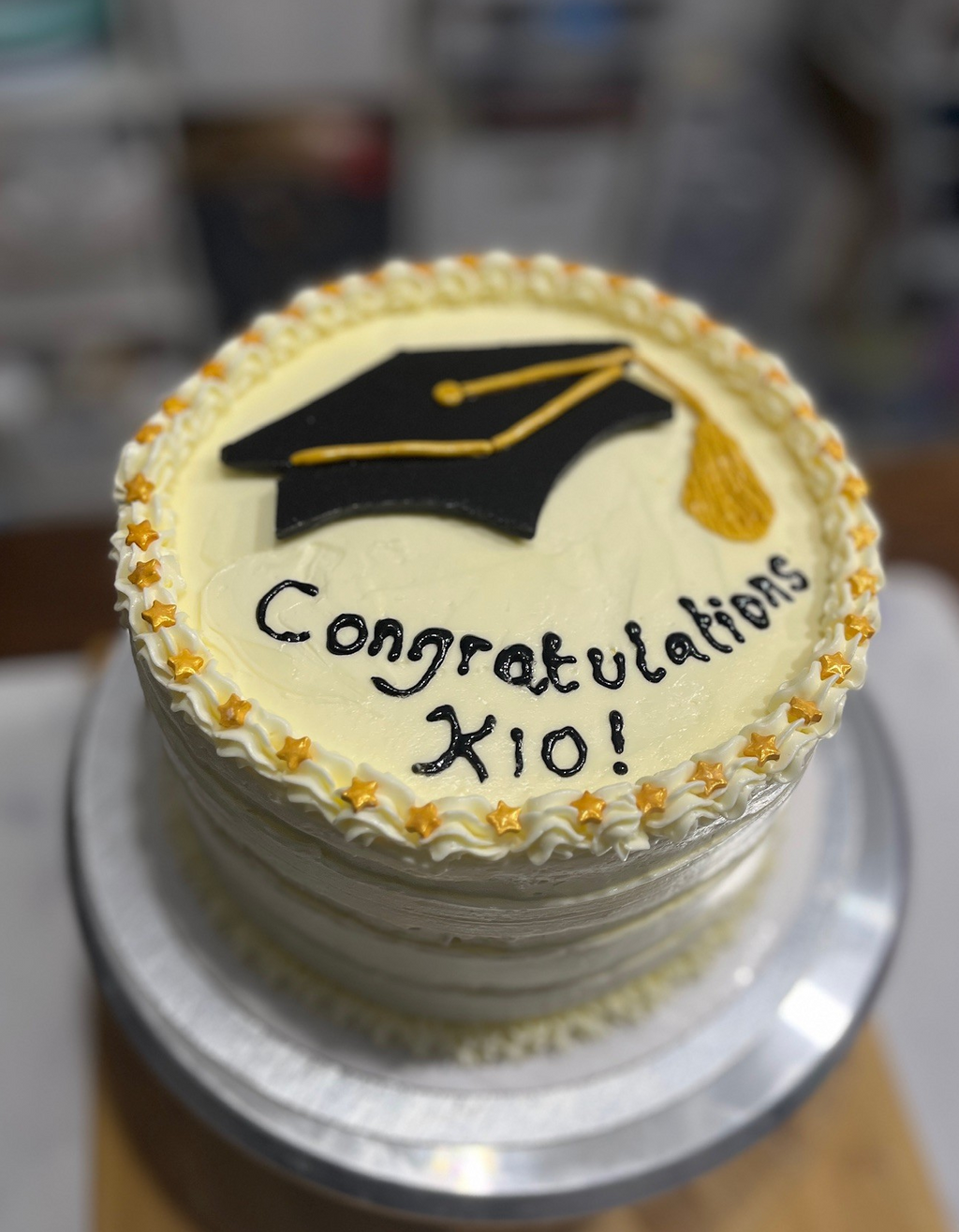 Graduation Cake with Black Cap and Gold Star Decorations