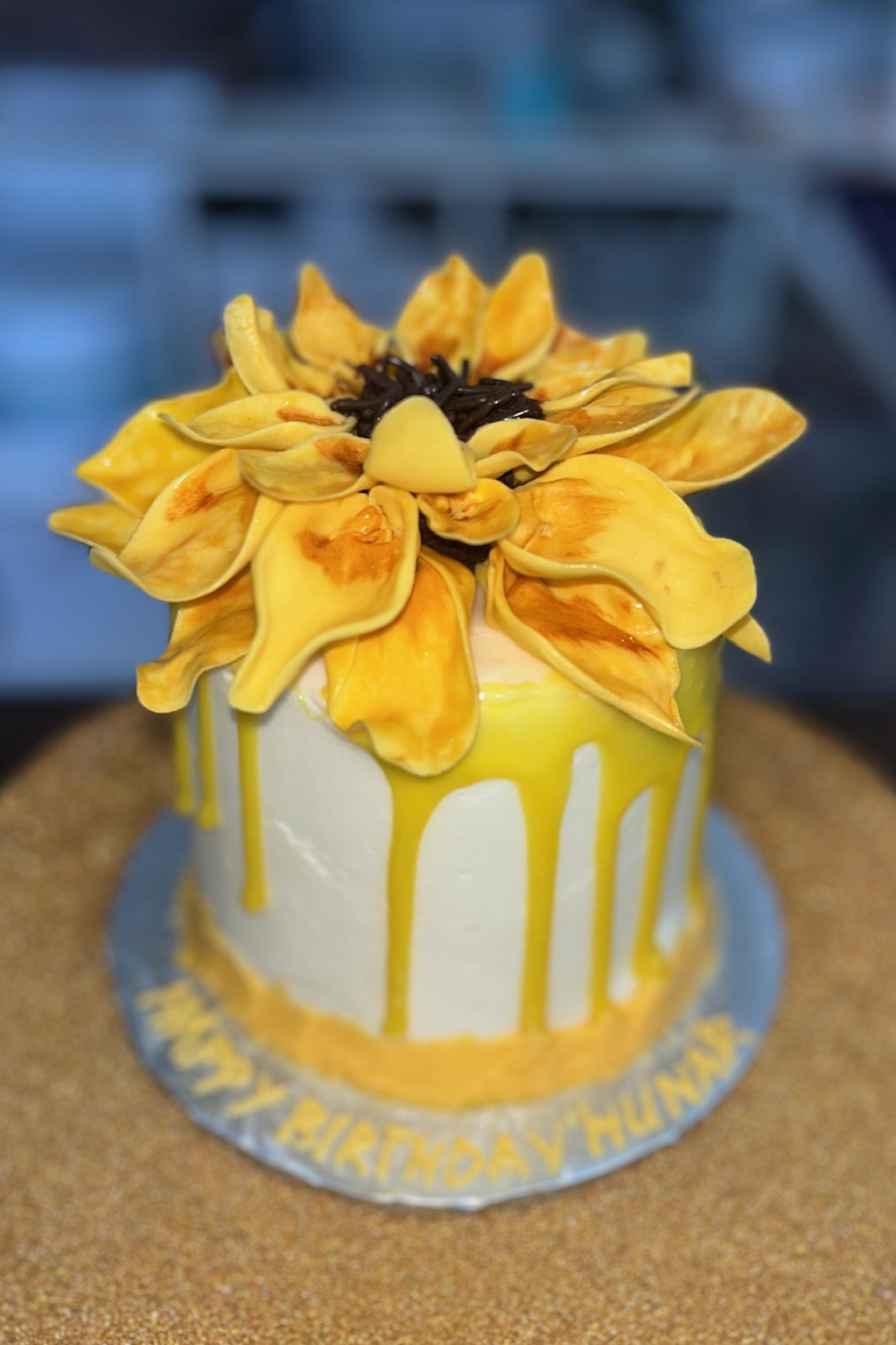Sunflower-Themed Birthday Cake with Yellow Drip and Fondant Flower